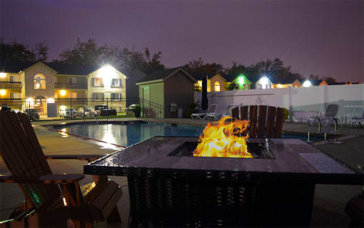 Night time image of fire pit located next to the pool