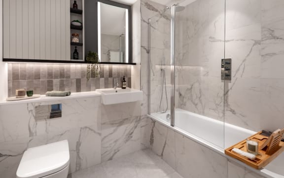 a bathroom with white marble walls and floor