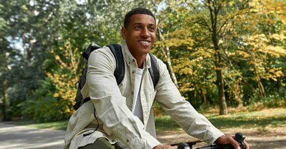 A man riding a bicycle in a park.