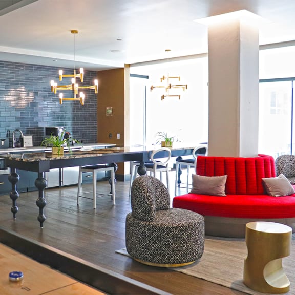 A modern dining area with a long table and chairs. at The Elle on Lockwood Apartments, Webster Groves, MO, 63119