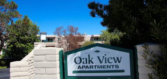 an apartment building with a sign for oak view apartments