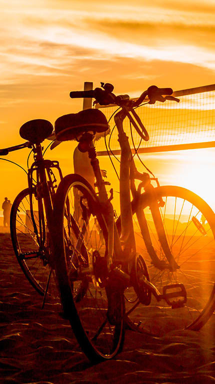 Lifestyle photo of someone plying beach volleyball and their bicycle at Villa Hermosa, Miami, FL, 33174