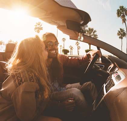 Lifestyle photo of couple driving at sunset at San Marco Apartments, Ormond Beach, FL, 32174