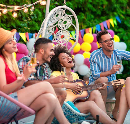 Lifestyle photo of friends playing the guitar and having fun at Tuscany Place Apartments, Florida