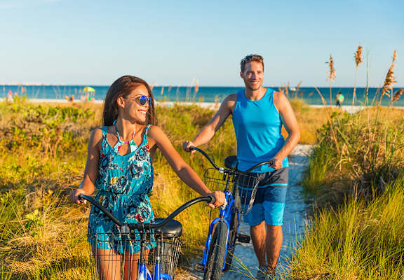 Lifestyle photo of couple on bikes at the beach at Renaissance, Florida, 33409