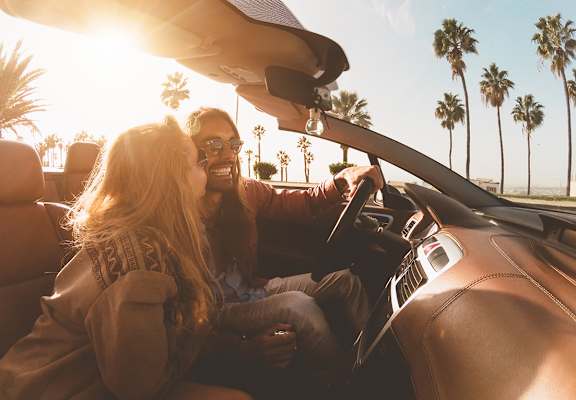 Lifestyle photo of couple driving at sunset at Mission Pointe Apartments, Jacksonville 32218