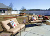 Thumbnail 7 of 8 - A patio with a couch and chairs.