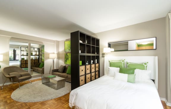 a bedroom with a bed and a living room