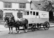 Thumbnail 5 of 8 - Two horses pulling a carriage with the sign Almifo on it.