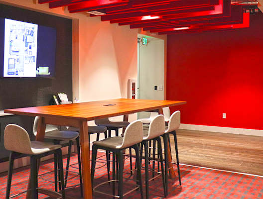 A conference room with a long table and chairs. at The Elle on Lockwood Apartments, Webster Groves, MO, 63119
