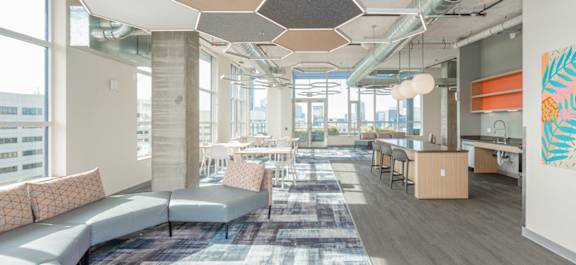 A modern office space with a large open area and a view of the city.