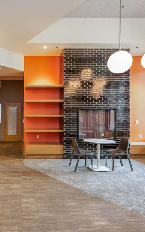 A modern office space with a colorful geometric design on the wall.