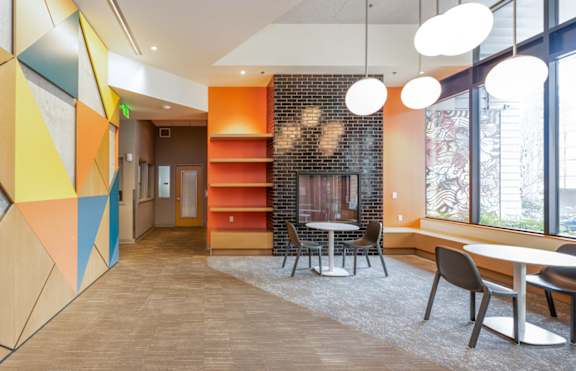 A modern office space with a colorful geometric design on the wall.