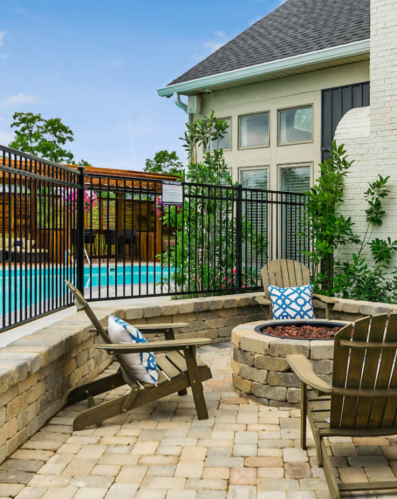 an outdoor kitchen with stainless steel appliances and bar stools