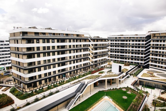 a view of a large building with a fountain in the middle