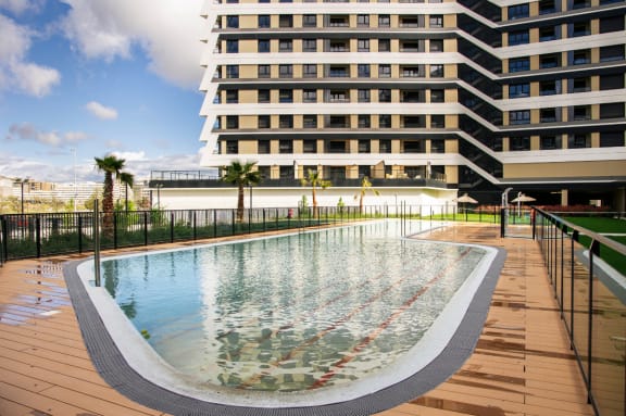 a swimming pool with a building in the background