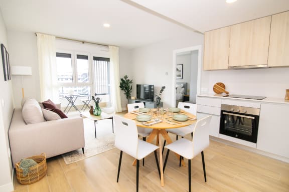 a living room with a table and chairs and a fireplace