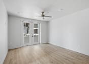 Thumbnail 25 of 51 - A room with a sliding door and a ceiling fan at Brickside Heights, Utah, 84106