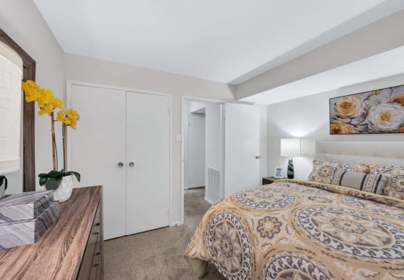 a bedroom with a bed and a dresser