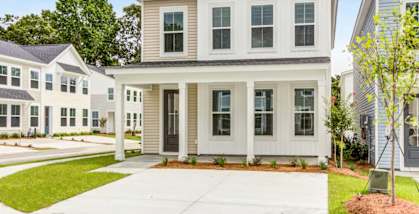 A two-story house with a front porch and a small front yard.