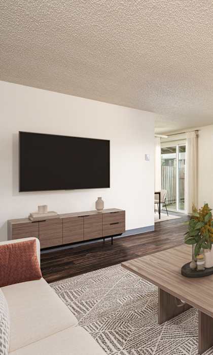 A living room with a flat screen TV mounted on the wall.
