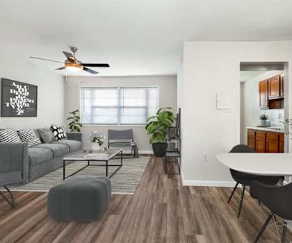 a living room with a couch and a table and a ceiling fan