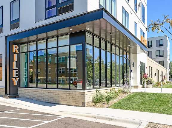A modern building with a glass facade and a sign that reads "RILEY".