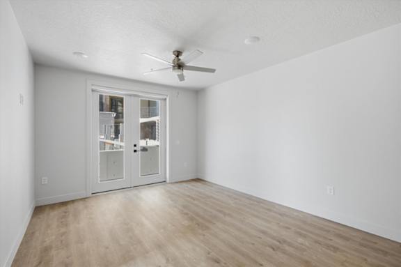 A room with a sliding door and a ceiling fan at Brickside Heights, Utah, 84106