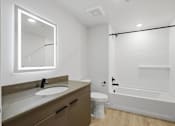 Thumbnail 8 of 51 - A white bathroom with a sink, toilet, and bathtub at Brickside Heights, Millcreek, UT, 84106