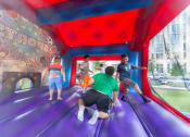 Thumbnail 8 of 9 - a group of kids playing on a trampoline