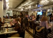 Thumbnail 2 of 9 - people sitting at tables in a restaurant