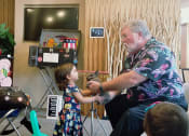 Thumbnail 1 of 9 - a little girl is petting a cat