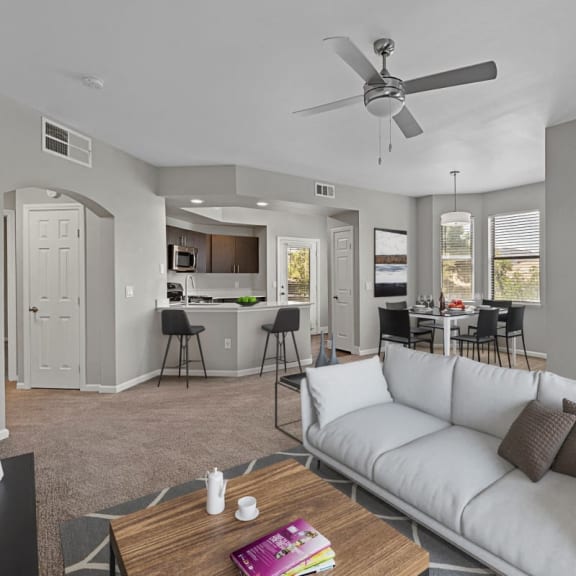 a living room with a couch and a ceiling fan