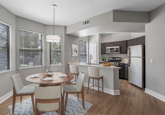a kitchen and dining room with a table and chairs