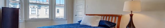 a bedroom with a bed and a dresser