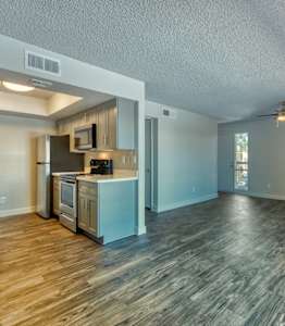A spacious kitchen with wood flooring and a ceiling fan. at Tela Verde, Glendale, AZ, 85306