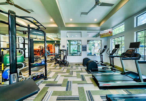 A gym with a variety of equipment including treadmills, weights, and exercise machines at Monument, Arizona