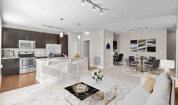 a living room and kitchen with a couch and a table
