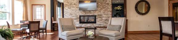 a living room with couches and chairs and a fireplace