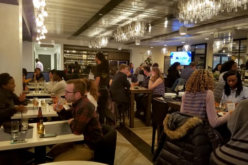 people sitting at tables in a restaurant