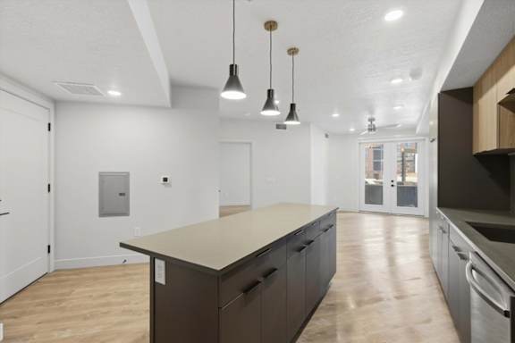 A kitchen with a large island and pendant lights at Brickside Heights, Millcreek, Utah