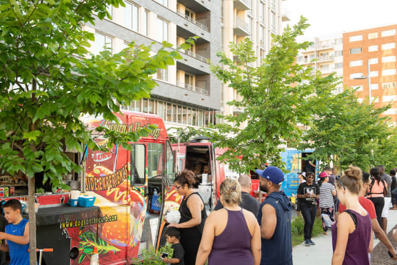 a group of people standing in front of food trucks