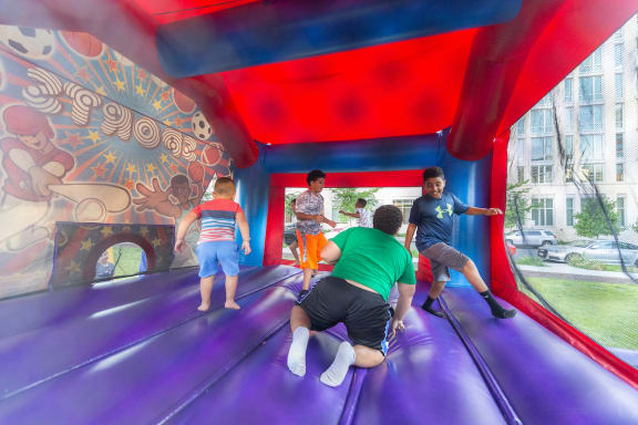 a group of kids playing on a trampoline