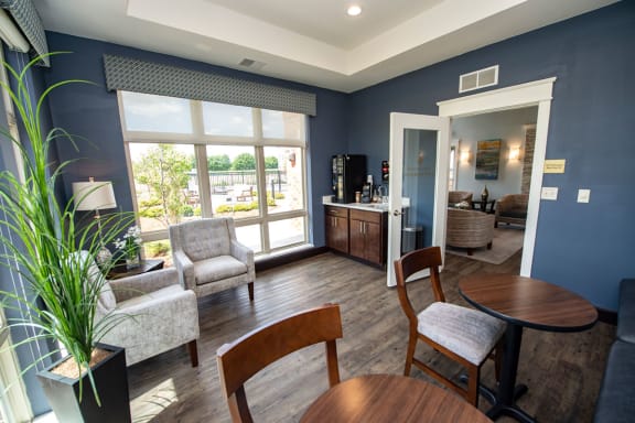 a living room with a table and chairs