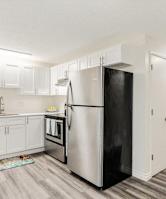 a kitchen with stainless steel appliances and white cabinets