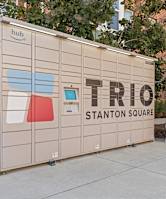 a small storage shed with the trio station square logo on it