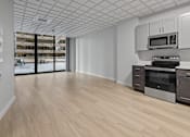 Thumbnail 2 of 4 - A kitchen with a white ceiling and wooden floors at Hampton Plaza Apartments, Towson, MD, 21286