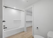 Thumbnail 46 of 51 - A white bathroom with a tub, toilet and sink at Brickside Heights, Millcreek