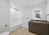 Thumbnail 44 of 51 - A white bathroom with a brown vanity and a toilet at Brickside Heights, Millcreek, UT, 84106