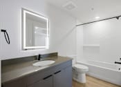 Thumbnail 13 of 51 - A modern bathroom with a white toilet and a white sink at Brickside Heights, Utah, 84106